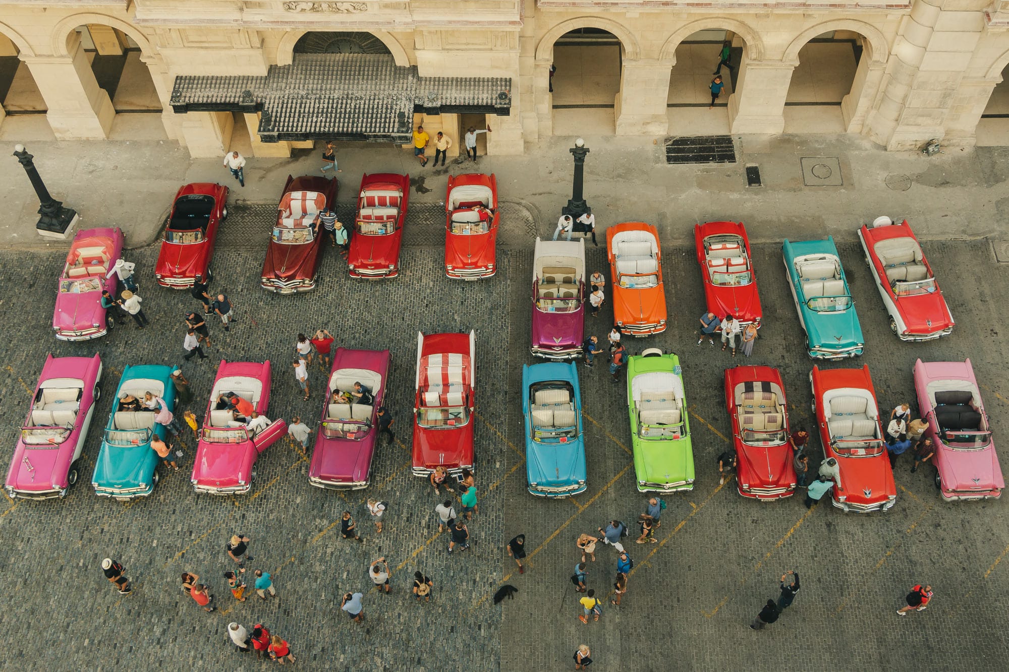 Classic-Convertibles-parked-outside-The-Manzana-Kempinski--Hotel-Havana-Cuba-Cosmopolitours