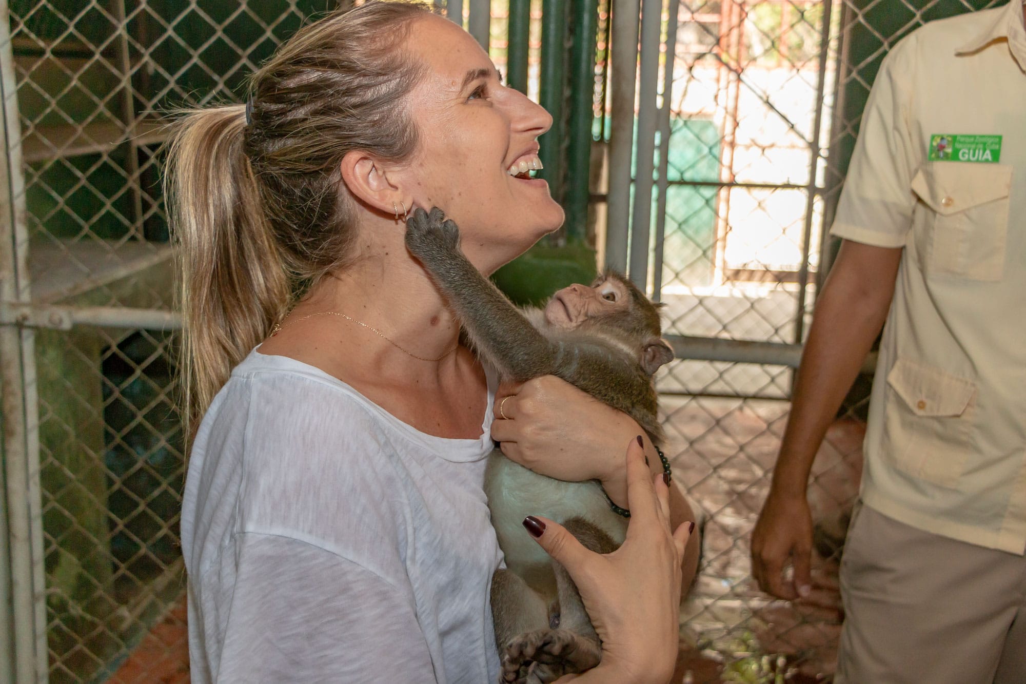 Cosmopolitours Client Feeding Baby Monkey at Zoos Nursery Cosmopolitours